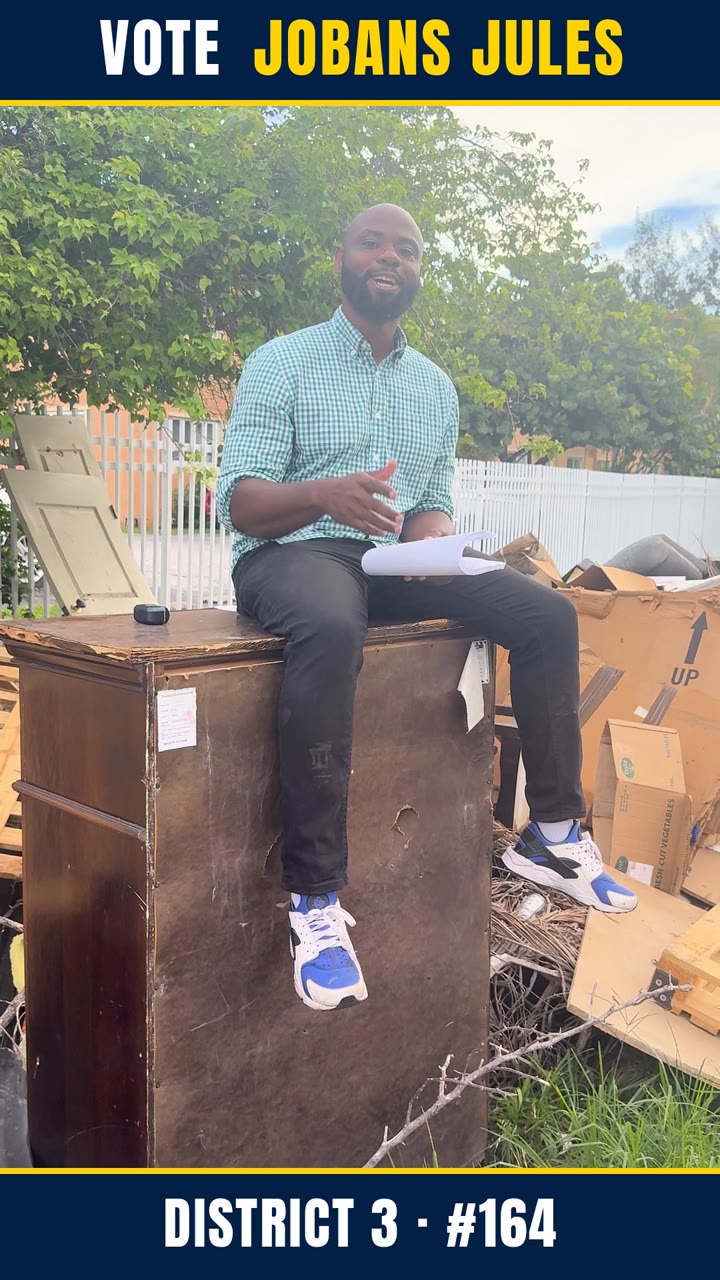 Jobans Jules sitting on a pile of dumped trash in North Miami, District 3, holding a lawsuit